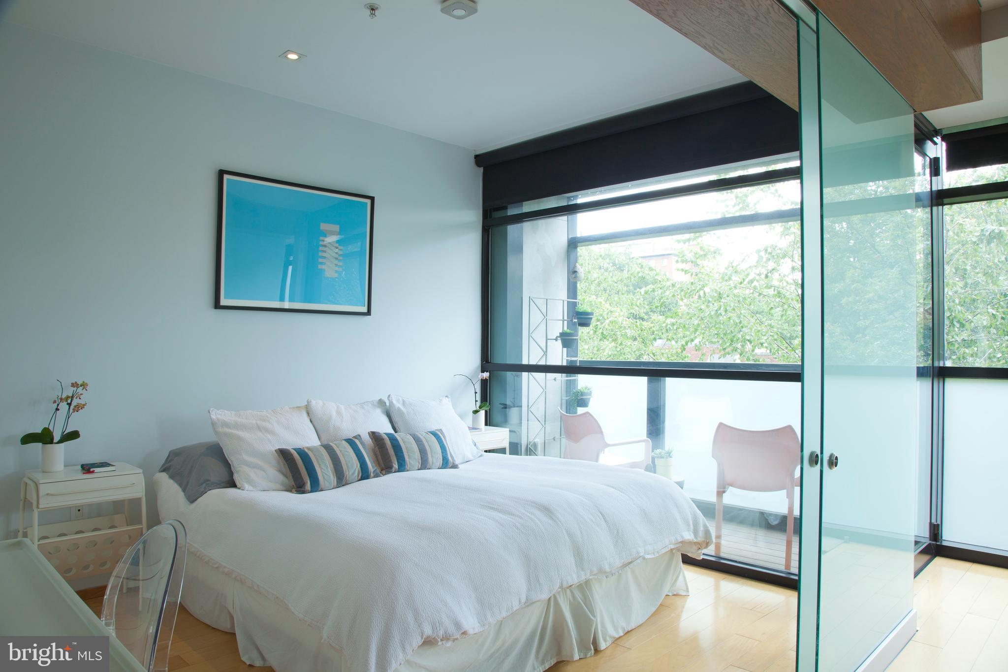 2250 11th Street Northwest, Unit 304 Washington, DC 20001 - Photo 7 of 17 a bedroom with a bed and a large window