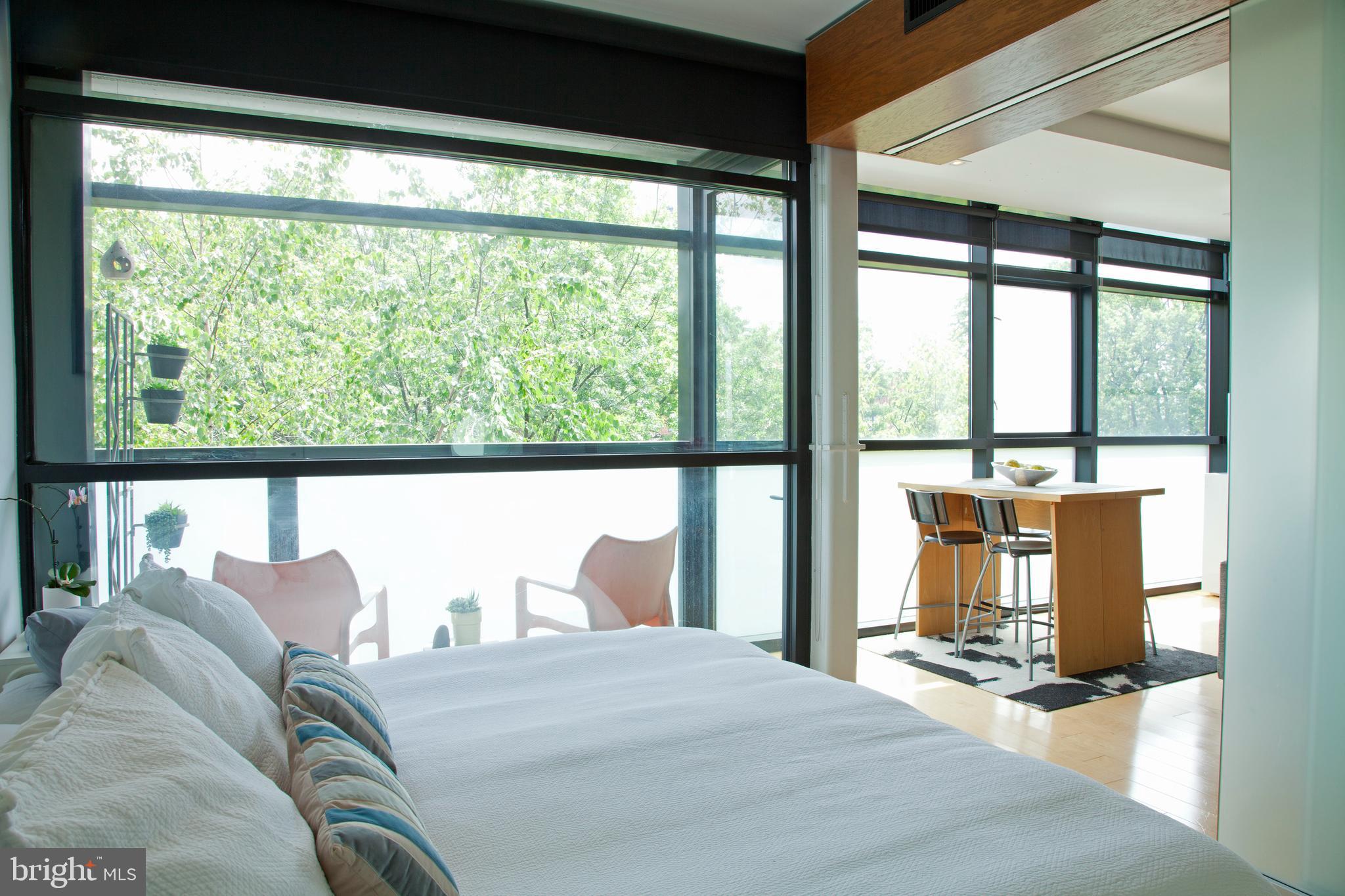 2250 11th Street Northwest, Unit 304 Washington, DC 20001 - Photo 8 of 17 a bed sitting in a bedroom next to a large window