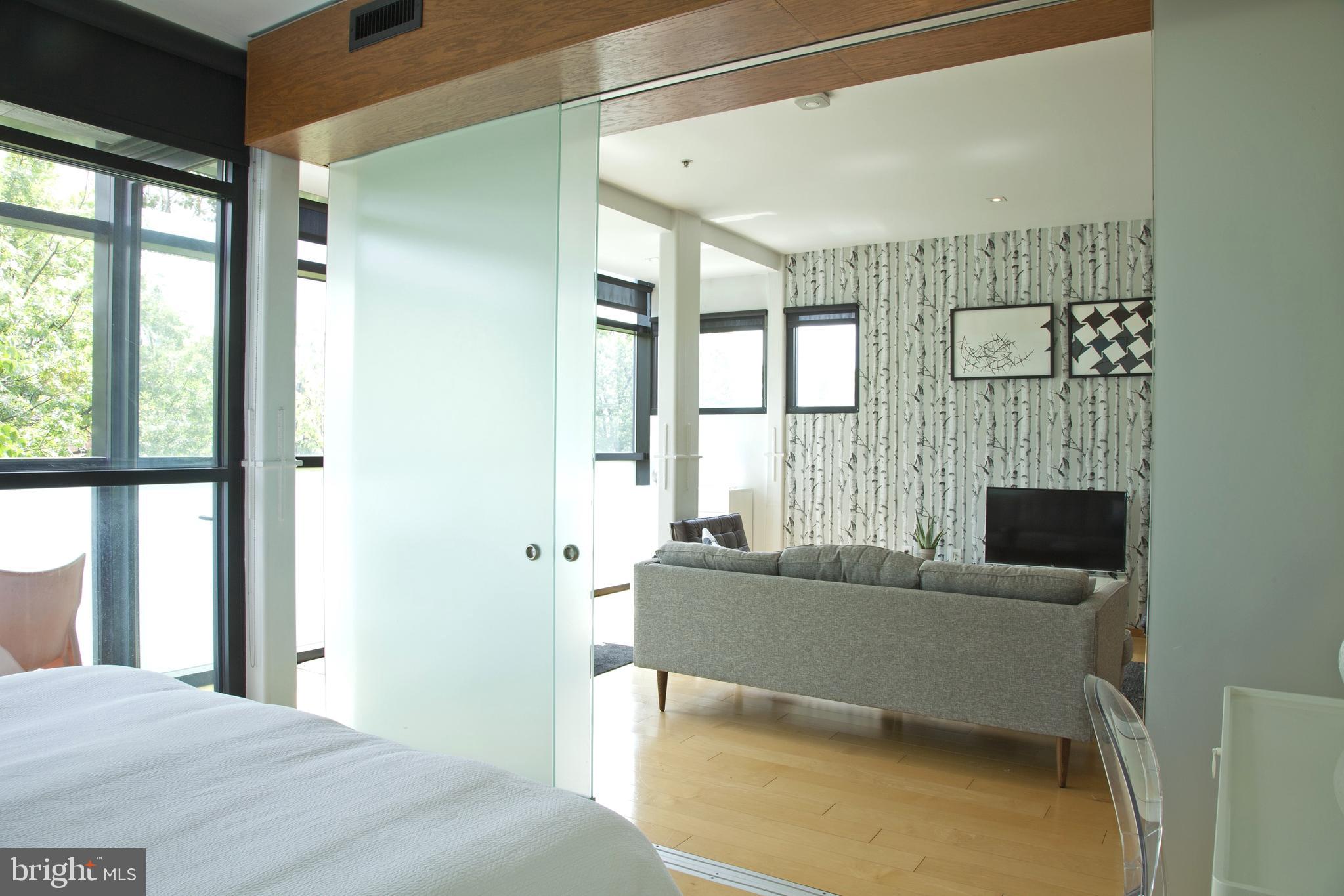 2250 11th Street Northwest, Unit 304 Washington, DC 20001 - Photo 9 of 17 a bedroom with a bed and large window