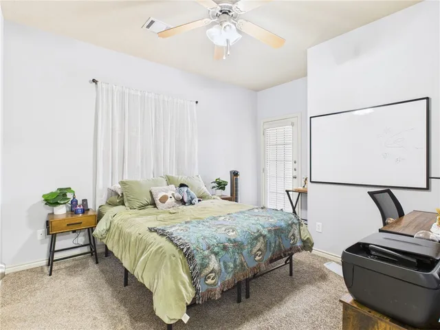 a bedroom with bed and a chandelier