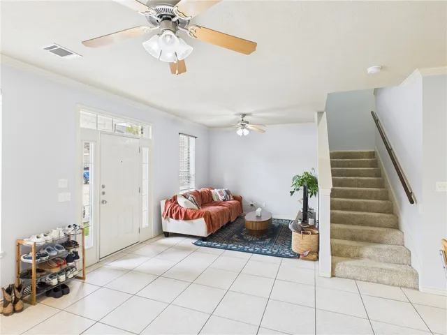 a bedroom with furniture and a chandelier fan