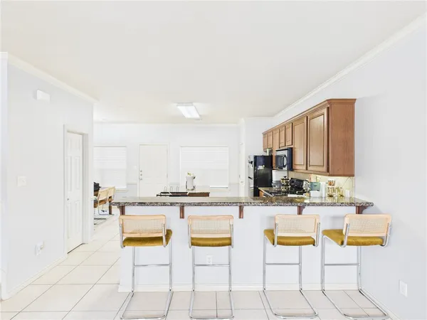 a kitchen with stainless steel appliances kitchen island granite countertop a sink and cabinets