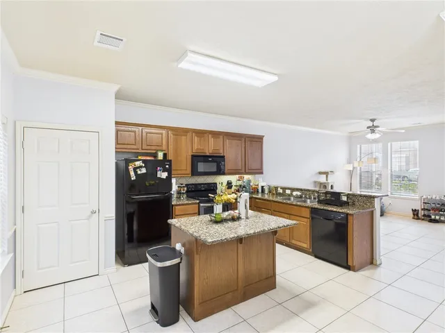 a kitchen with a stove top oven and refrigerator