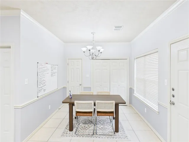 a bedroom with furniture and a chandelier