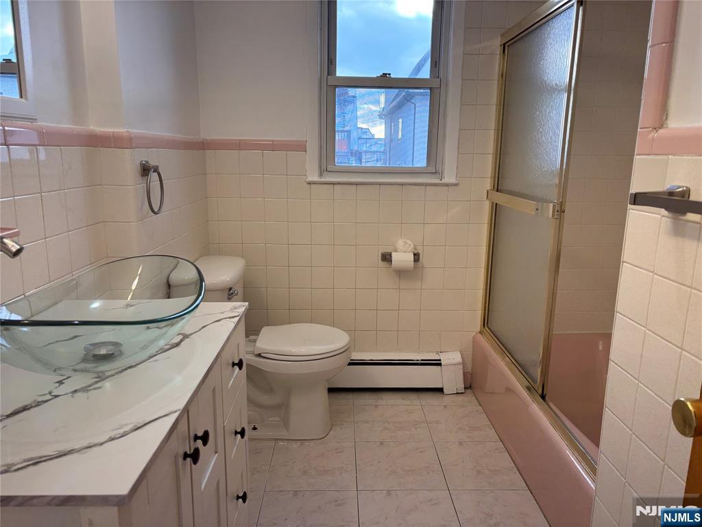 238 Clark Terrace, Unit 2 Cliffside Park, NJ 07010 - Photo 8 of 13 a bathroom with a sink a toilet and shower