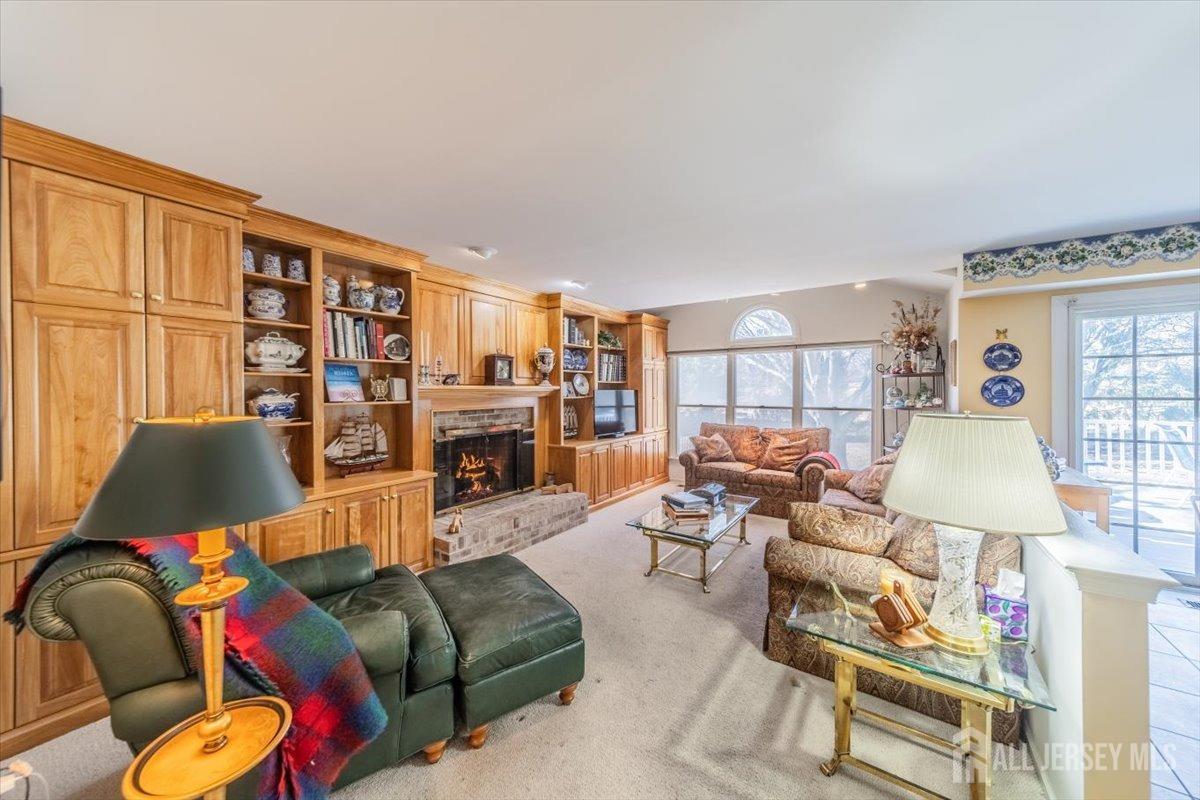 12 Adams Road Kendall Park, NJ 08824 - Photo 11 of 40 a living room with furniture a lamp and a large window