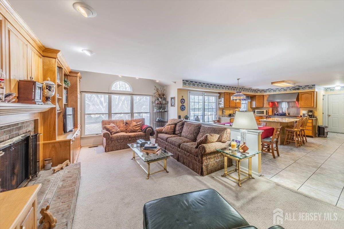 12 Adams Road Kendall Park, NJ 08824 - Photo 13 of 40 a living room with furniture and a fireplace