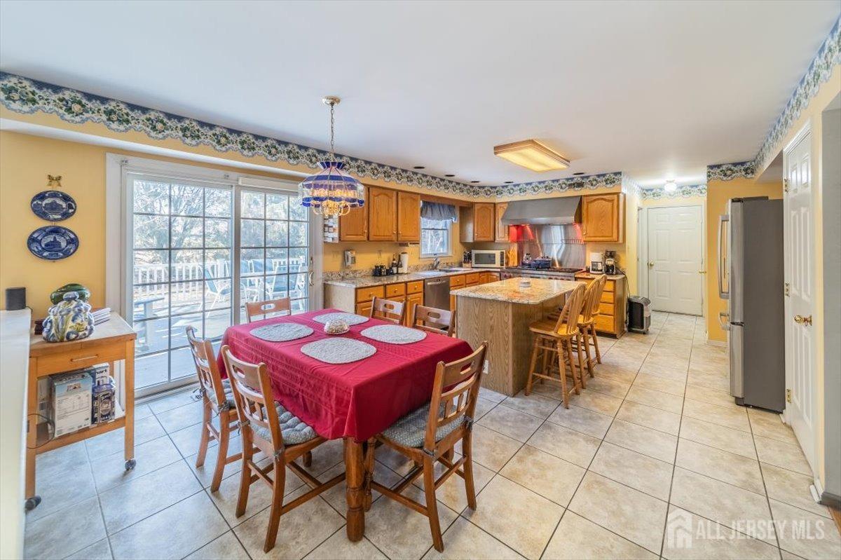 12 Adams Road Kendall Park, NJ 08824 - Photo 14 of 40 a view of a dining room with furniture and chandelier