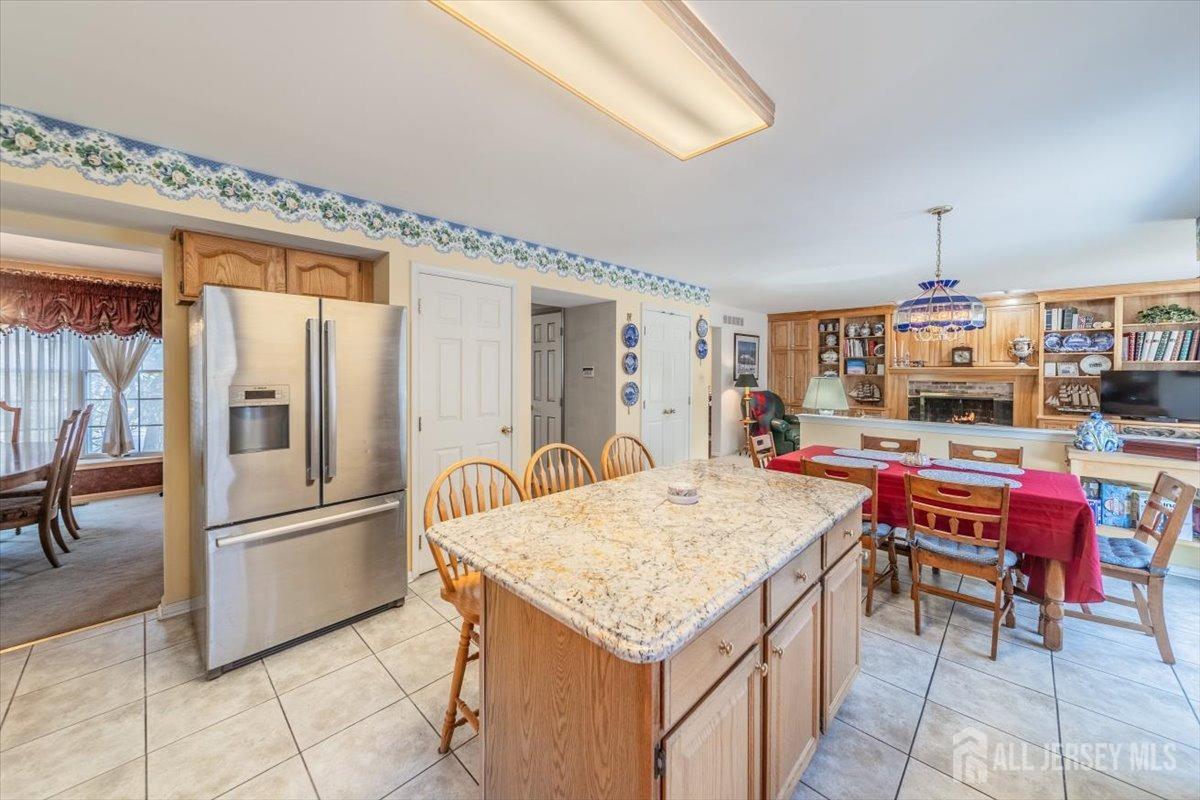 12 Adams Road Kendall Park, NJ 08824 - Photo 17 of 40 a kitchen with kitchen island a counter top space appliances and cabinets