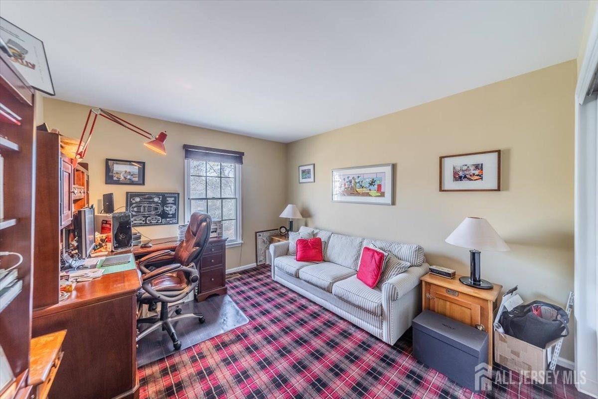12 Adams Road Kendall Park, NJ 08824 - Photo 21 of 40 a living room with furniture and a flat screen tv