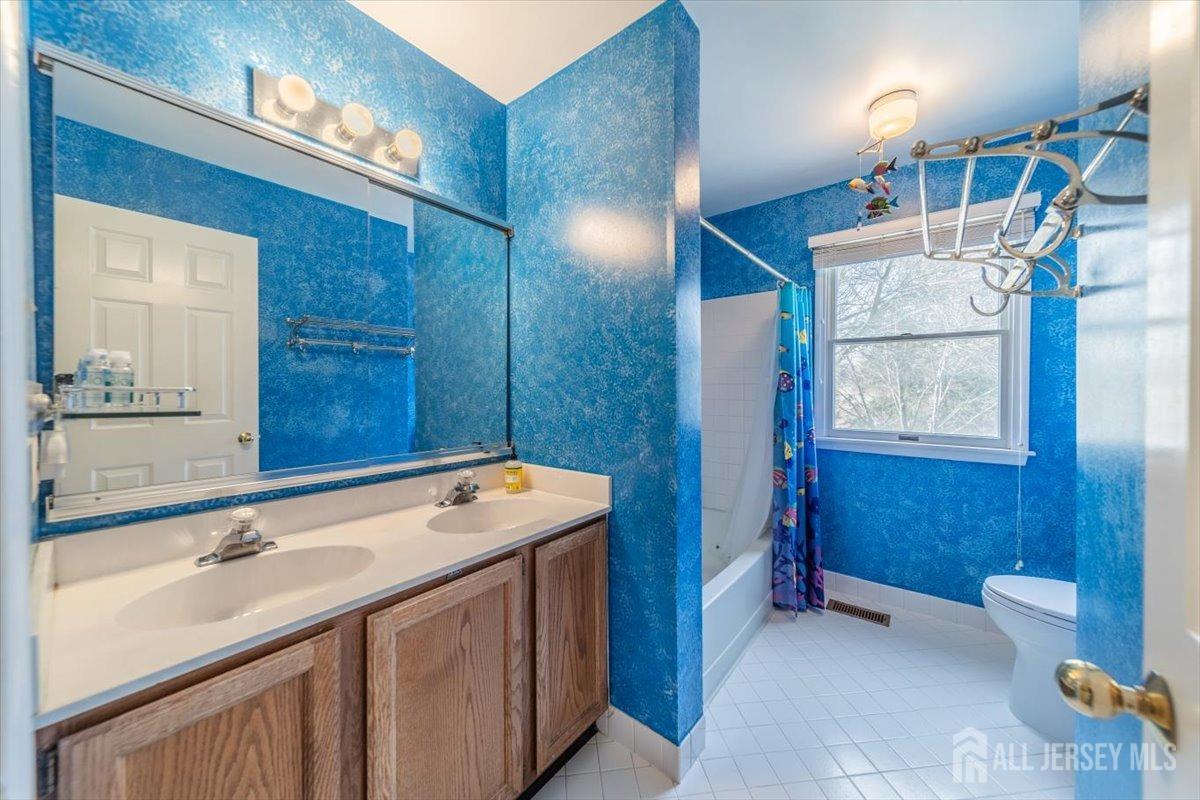 12 Adams Road Kendall Park, NJ 08824 - Photo 25 of 40 a bathroom with a sink double vanity and a mirror