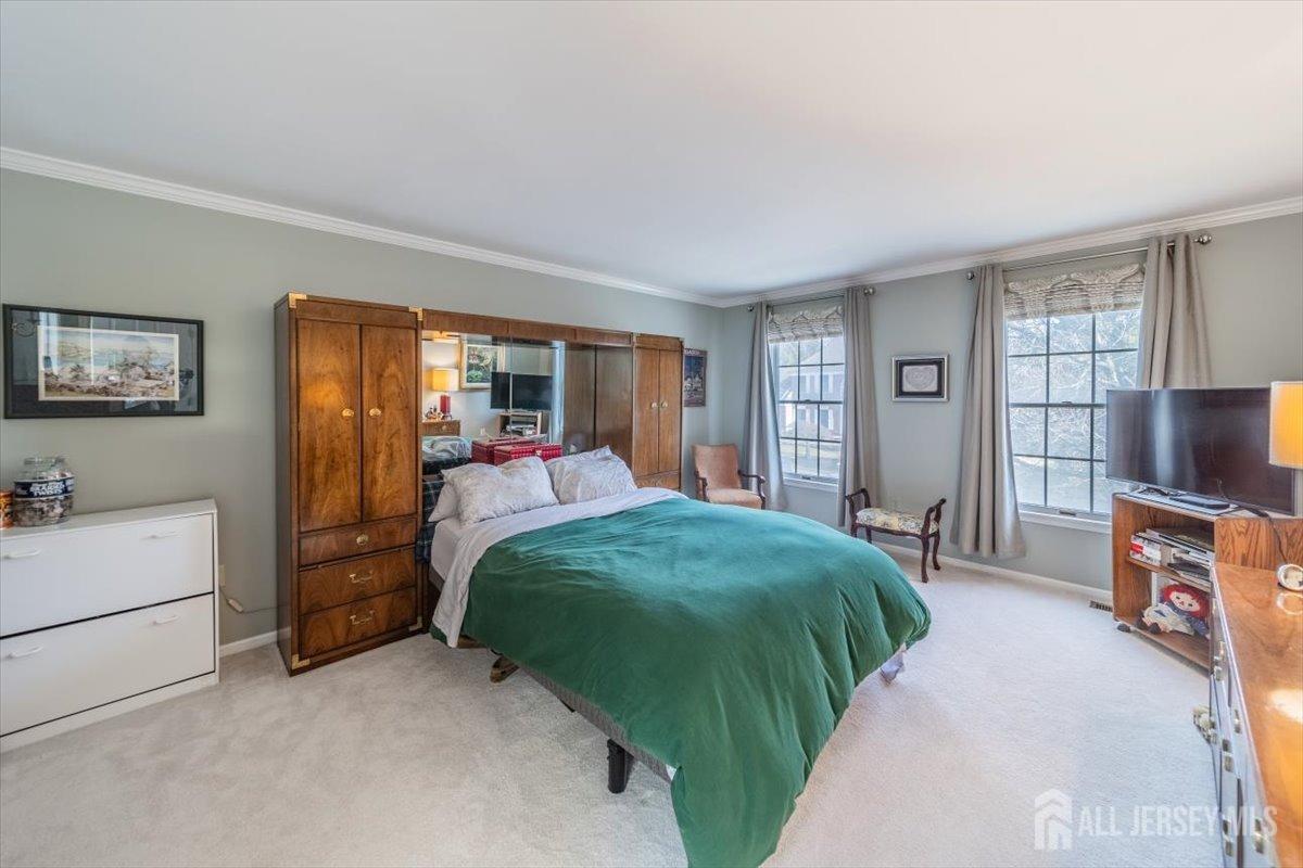 12 Adams Road Kendall Park, NJ 08824 - Photo 26 of 40 a living room with a bed and a flat tv screen on dresser