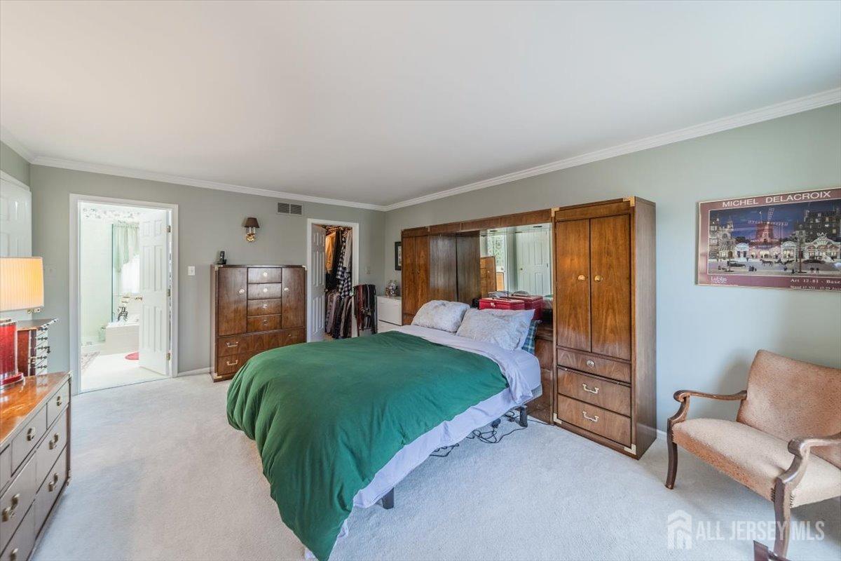 12 Adams Road Kendall Park, NJ 08824 - Photo 27 of 40 a spacious bedroom with a bed and a couch