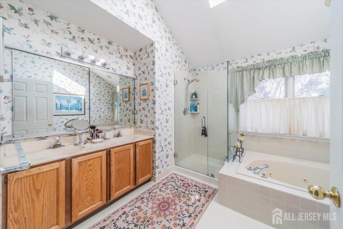 12 Adams Road Kendall Park, NJ 08824 - Photo 28 of 40 a bathroom with a tub sink and mirror