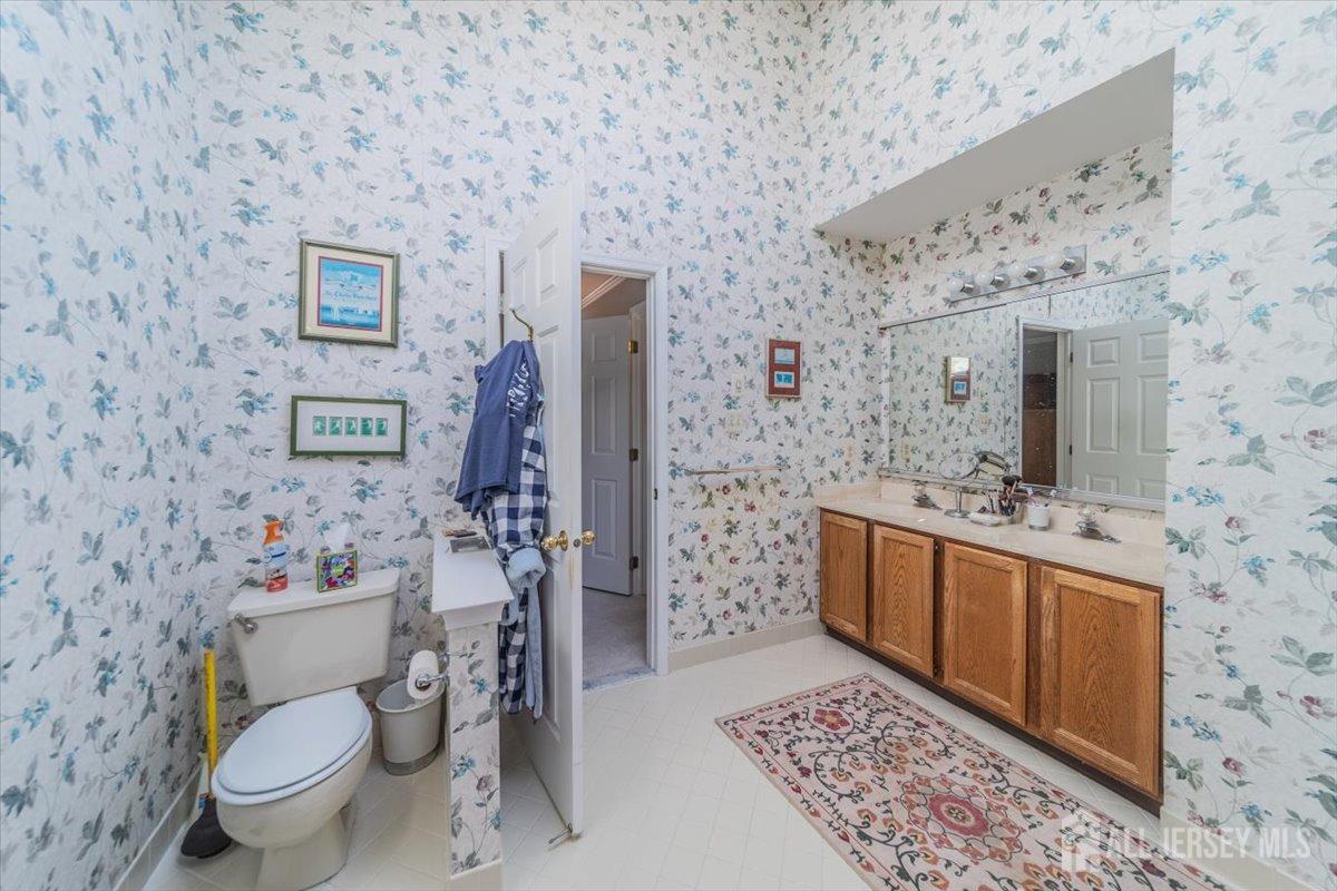 12 Adams Road Kendall Park, NJ 08824 - Photo 29 of 40 a bathroom with a toilet sink and mirror