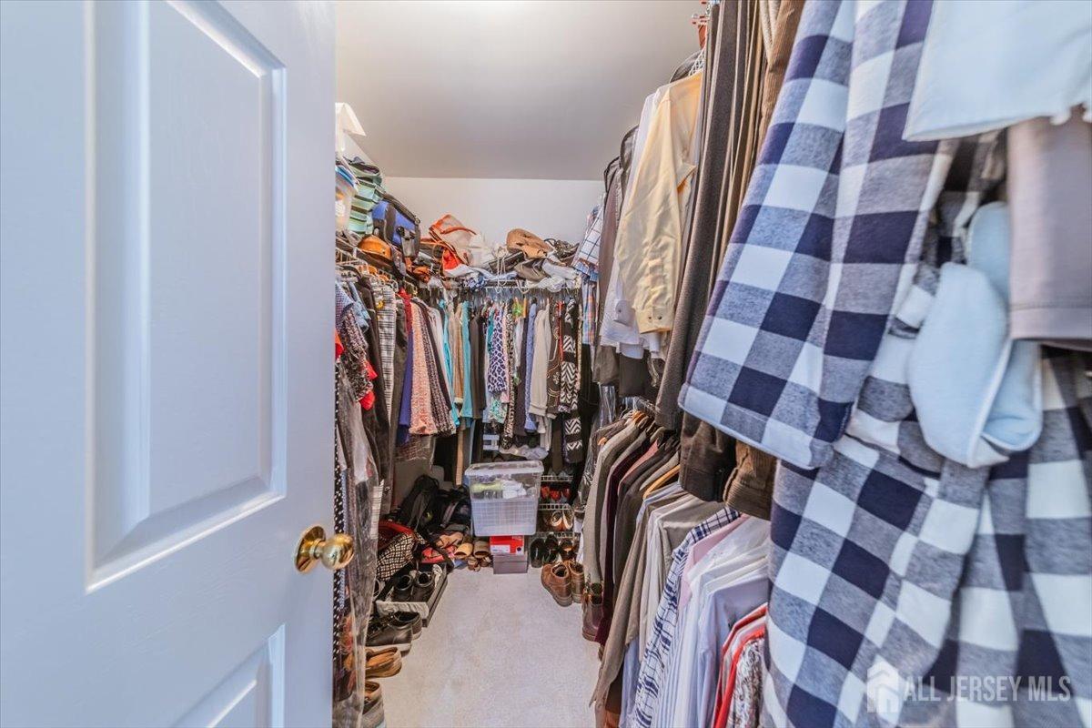 12 Adams Road Kendall Park, NJ 08824 - Photo 31 of 40 a view of walk in closet with clothes