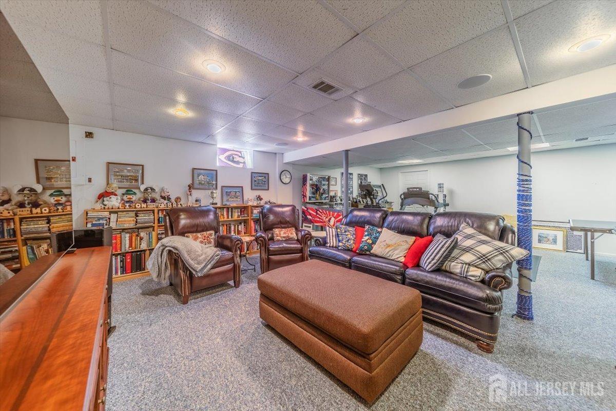 12 Adams Road Kendall Park, NJ 08824 - Photo 32 of 40 a living room with furniture a couch and lots of tables