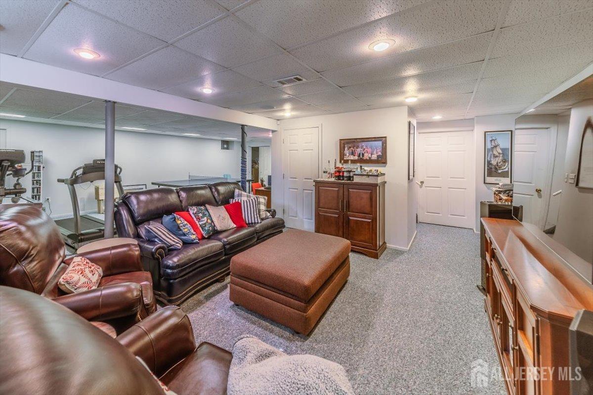 12 Adams Road Kendall Park, NJ 08824 - Photo 33 of 40 a living room with furniture and a flat screen tv