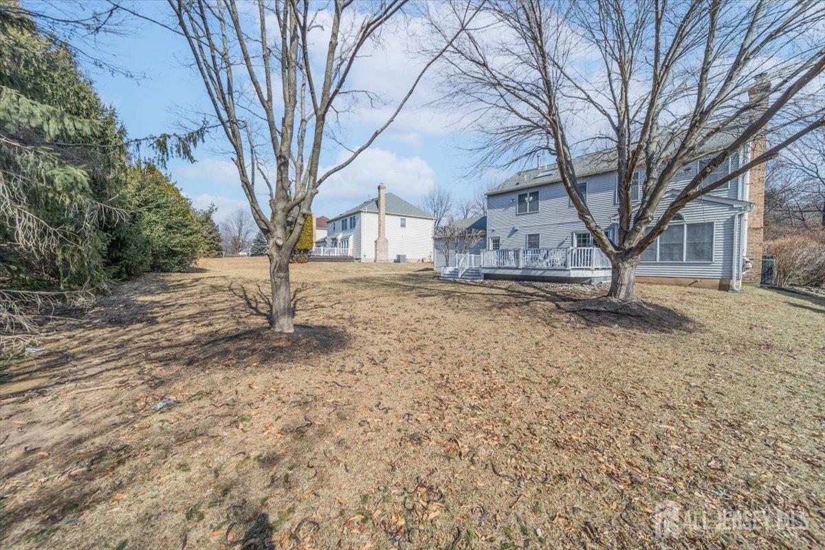 12 Adams Road Kendall Park, NJ 08824 - Photo 38 of 40 a backyard of a house with a large tree