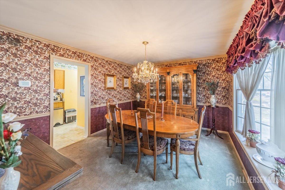 12 Adams Road Kendall Park, NJ 08824 - Photo 7 of 40 a dining room with furniture and chandelier kitchen view