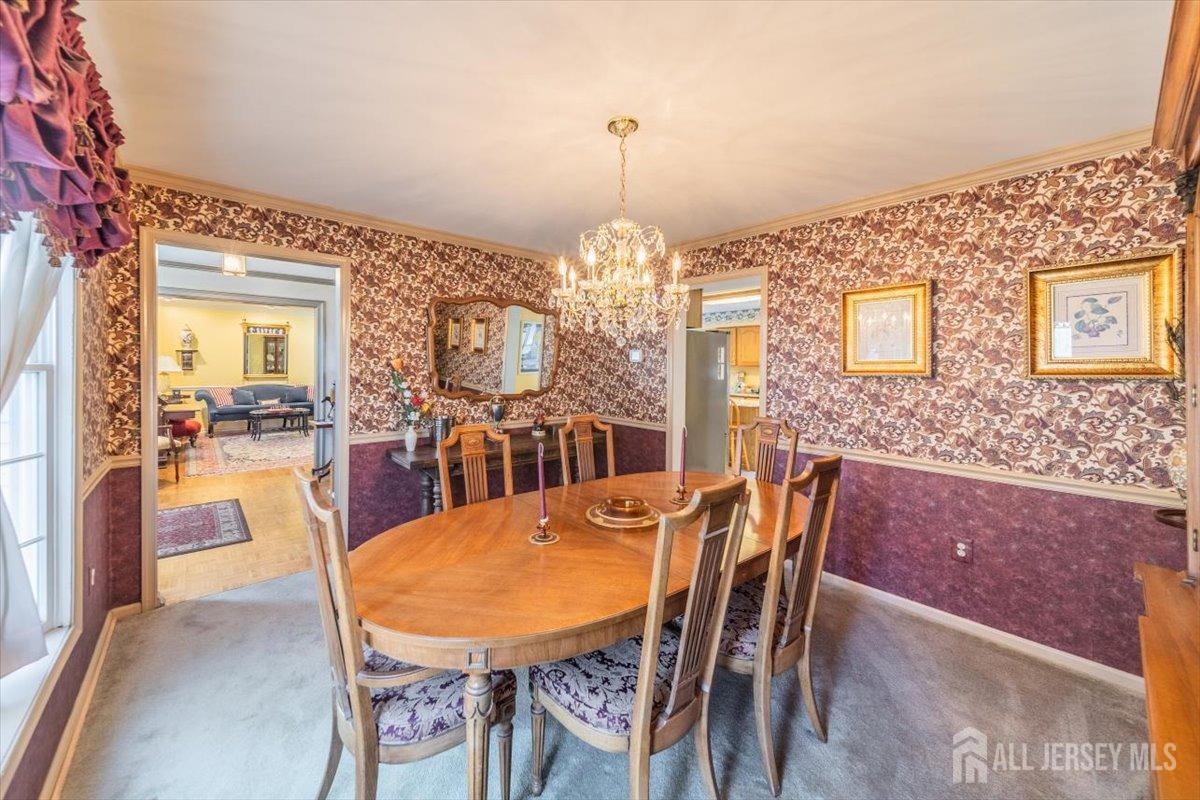 12 Adams Road Kendall Park, NJ 08824 - Photo 8 of 40 a view of a dining room with furniture and a chandelier