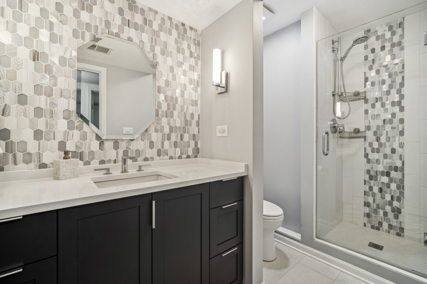 940 Sutton Drive Northbrook, IL 60062 - Photo 12 of 16 a bathroom with a sink and a mirror