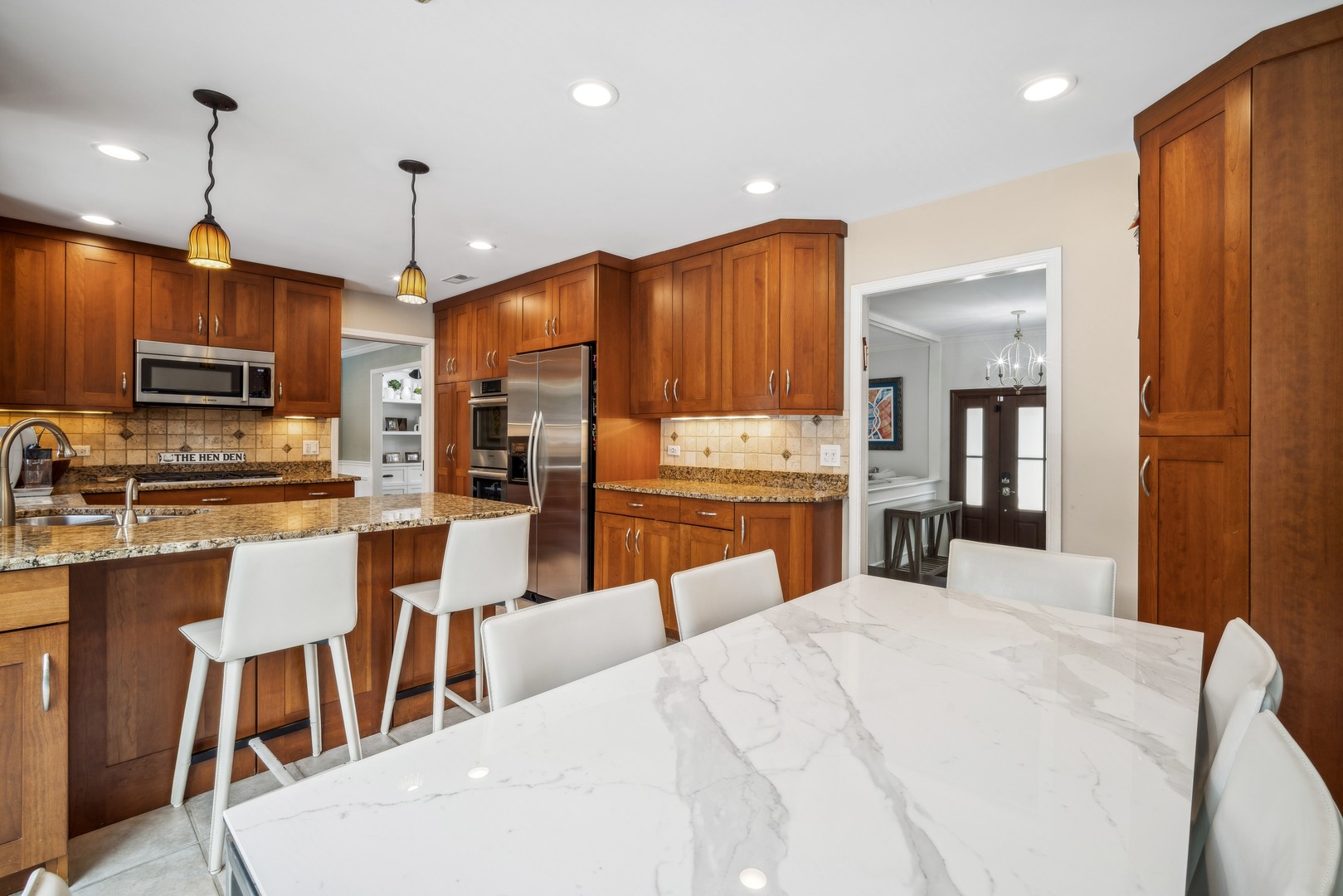 940 Sutton Drive Northbrook, IL 60062 - Photo 8 of 16 a large kitchen with kitchen island a large island in it