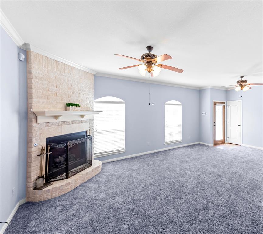 32 North Shore Circle Waco, TX 76708 - Photo 6 of 26 a view of livingroom with a fireplace a ceiling fan and window