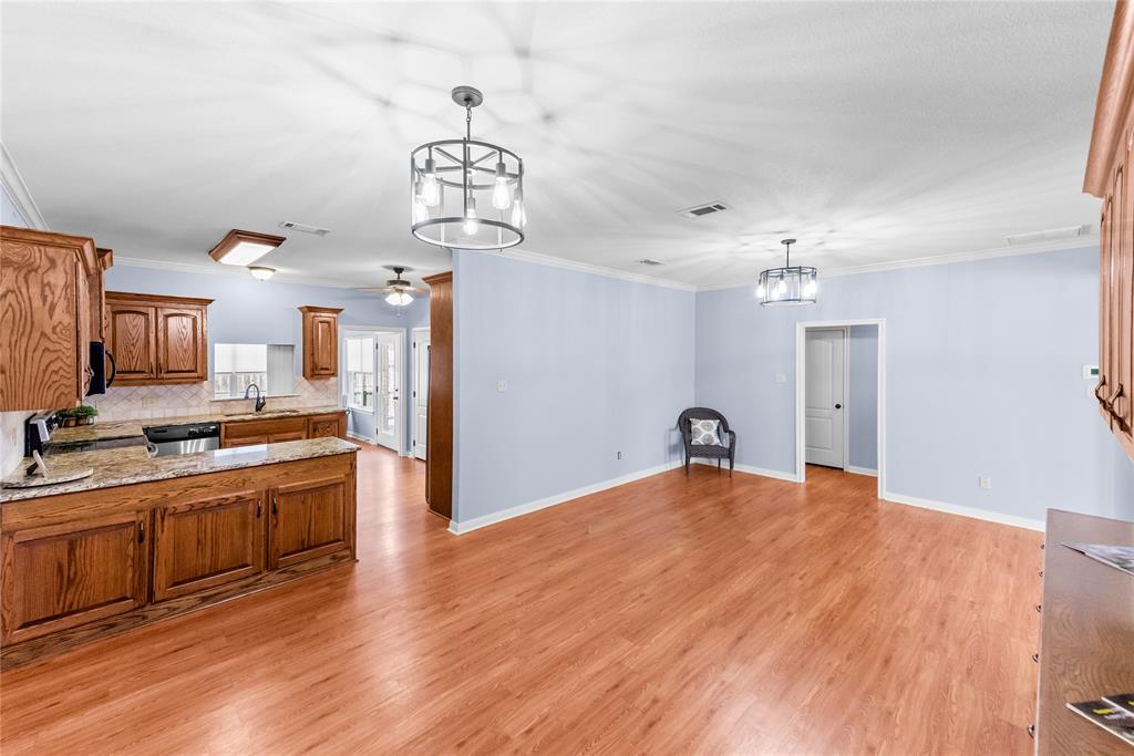32 North Shore Circle Waco, TX 76708 - Photo 7 of 26 a large kitchen with stainless steel appliances granite countertop a stove and cabinets with wooden floor