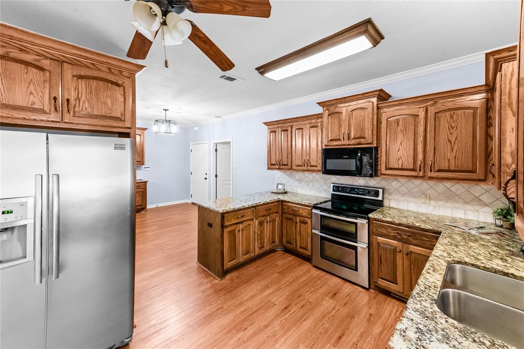 32 North Shore Circle Waco, TX 76708 - Photo 8 of 26 a kitchen with stainless steel appliances granite countertop a refrigerator a stove top oven a sink and dishwasher