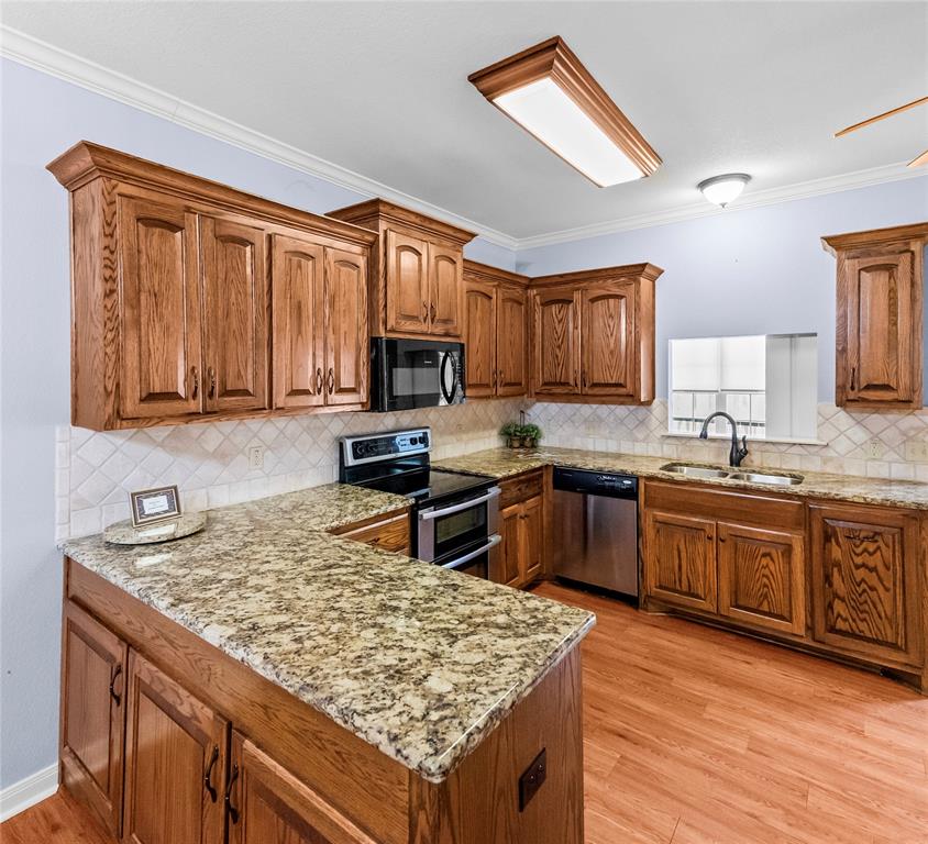 32 North Shore Circle Waco, TX 76708 - Photo 9 of 26 a kitchen with granite countertop wooden cabinets a stove top oven and granite counter tops