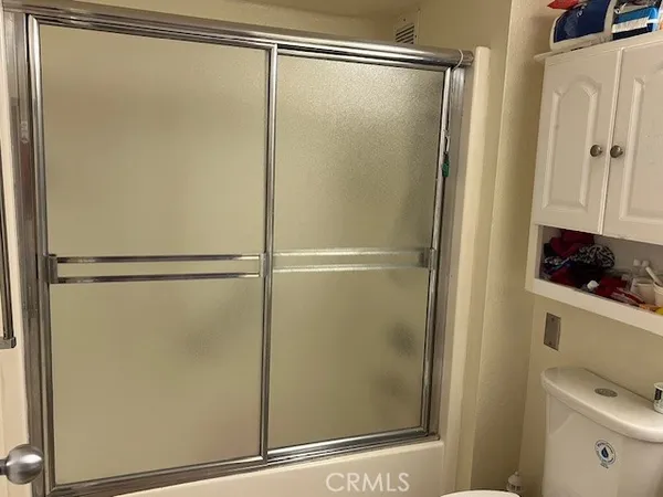 a bathroom with a glass shower door