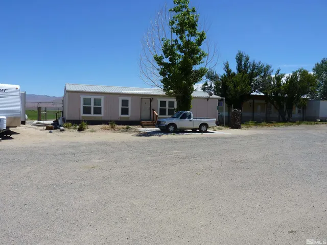 a row of palm trees in front of house