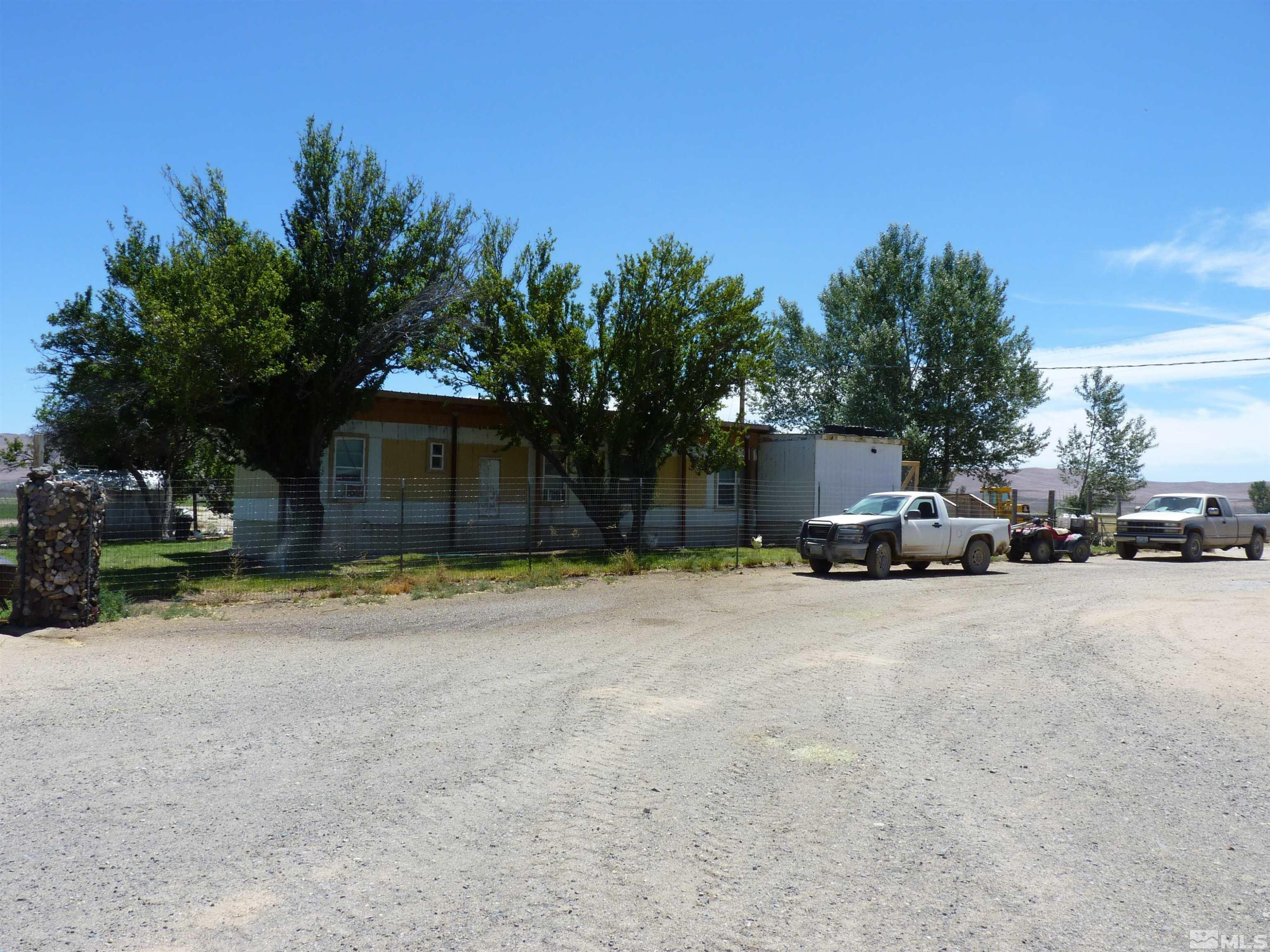 51955 Wilder Creek Road Denio, NV 89404 - Photo 15 of 36 a view of a house with a yard and garage