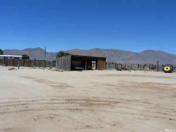 a view of a house with a yard and mountain