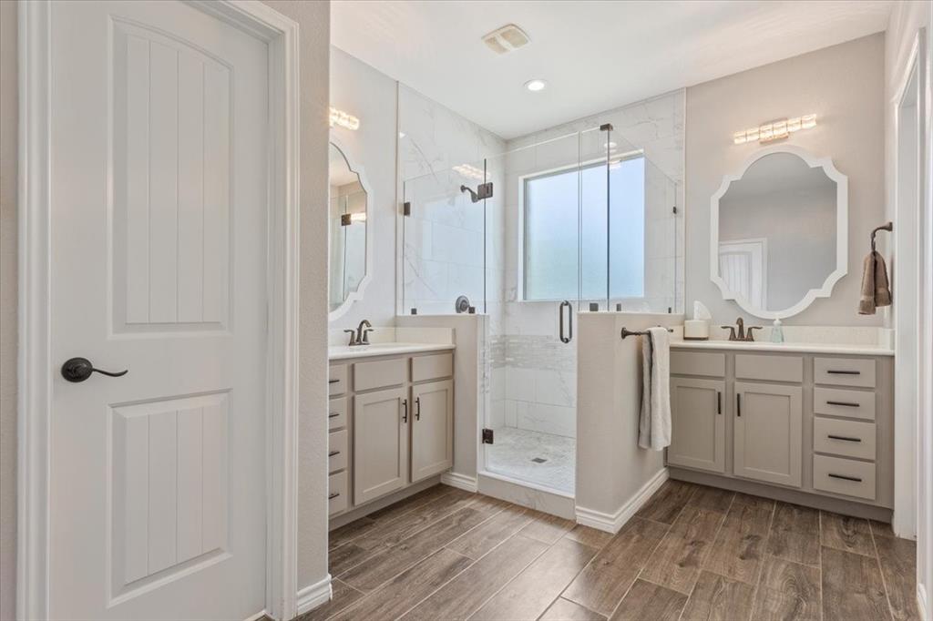 101 Rancho Lorena Drive Lorena, TX 76655 - Photo 22 of 40 a spacious bathroom with a double vanity sink a mirror and shower