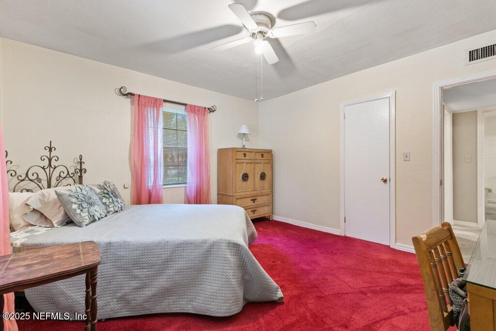 1445 Somerville Road Jacksonville, FL 32207 - Photo 24 of 49 a bedroom with a bed and wooden floor