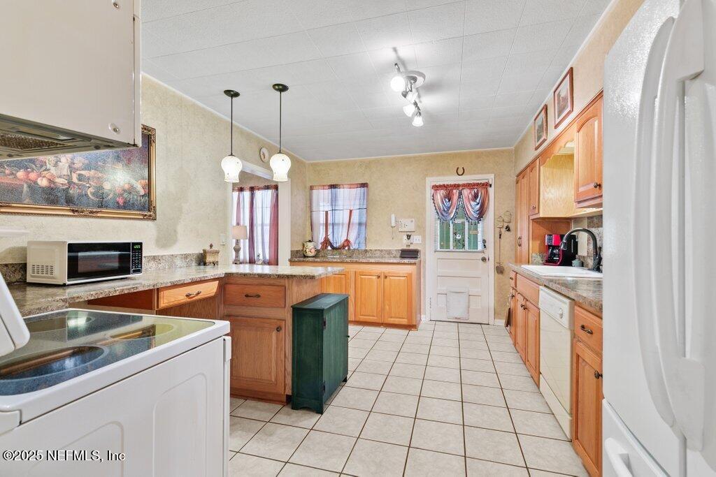 1445 Somerville Road Jacksonville, FL 32207 - Photo 32 of 49 a large kitchen with stainless steel appliances granite countertop a sink and cabinets