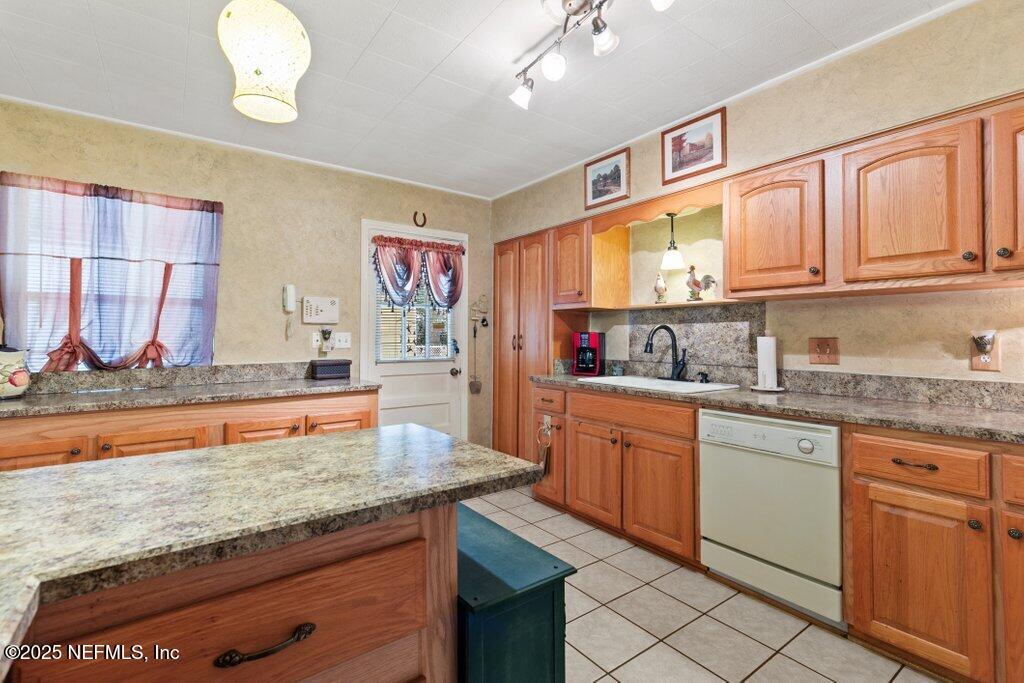 1445 Somerville Road Jacksonville, FL 32207 - Photo 38 of 49 a kitchen with stainless steel appliances granite countertop a stove a sink and a microwave