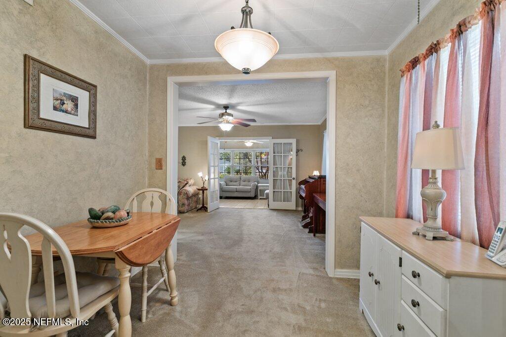 1445 Somerville Road Jacksonville, FL 32207 - Photo 40 of 49 a view of a dining room with furniture and chandelier
