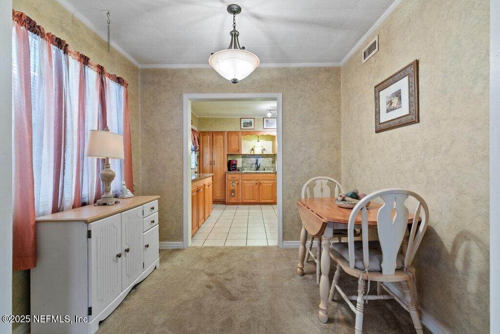 1445 Somerville Road Jacksonville, FL 32207 - Photo 41 of 49 a view of a dining room with furniture and chandelier