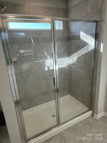 a bathroom with a glass shower door