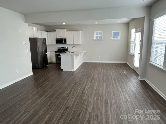 a kitchen with stainless steel appliances a refrigerator sink and microwave