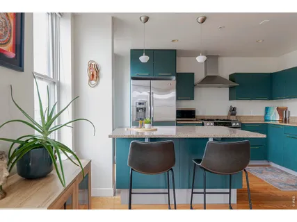 a kitchen with stainless steel appliances kitchen island granite countertop a sink and a stove