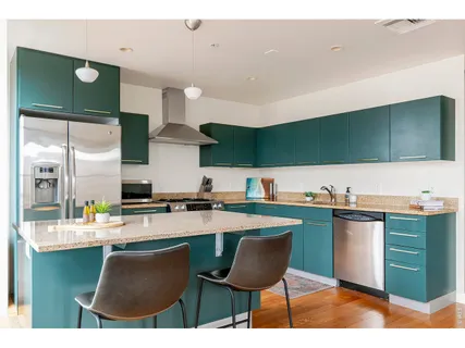 a kitchen with stainless steel appliances granite countertop a sink stove and cabinets