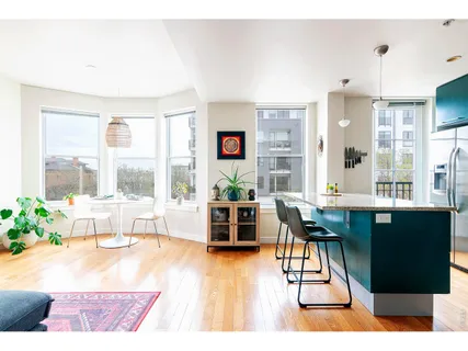 a room with a window a sink dishwasher and a refrigerator