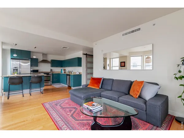 a living room with furniture a rug and a window