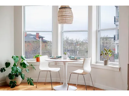 a dining room with furniture and a window