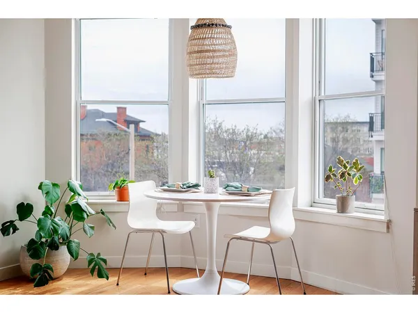 a dining room with furniture and a window