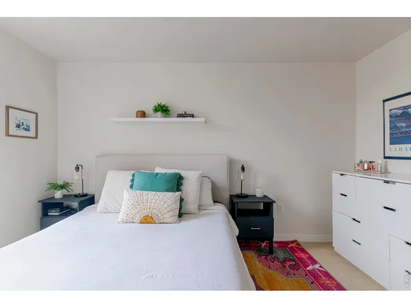 a bedroom with a bed and a dresser